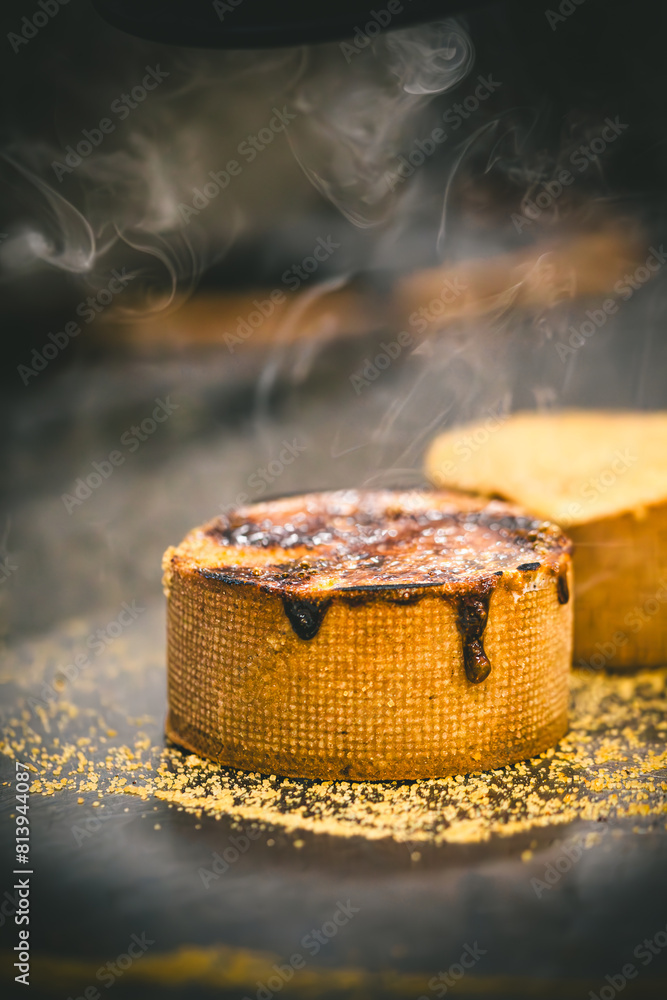 A tart is caramelized with a hot iron. Caramelization process. Vertical. A tart is caramelized with a hot iron. Caramelization process. Vertical.