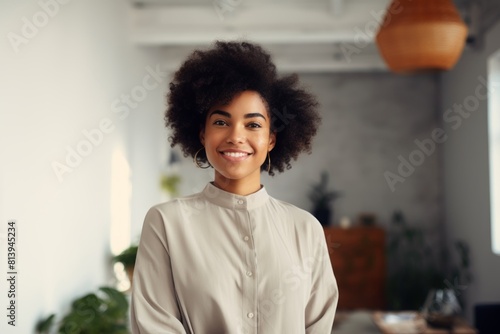 Portrait of a tender afro-american woman in her 20s smiling at the camera isolated on modern minimalist interior