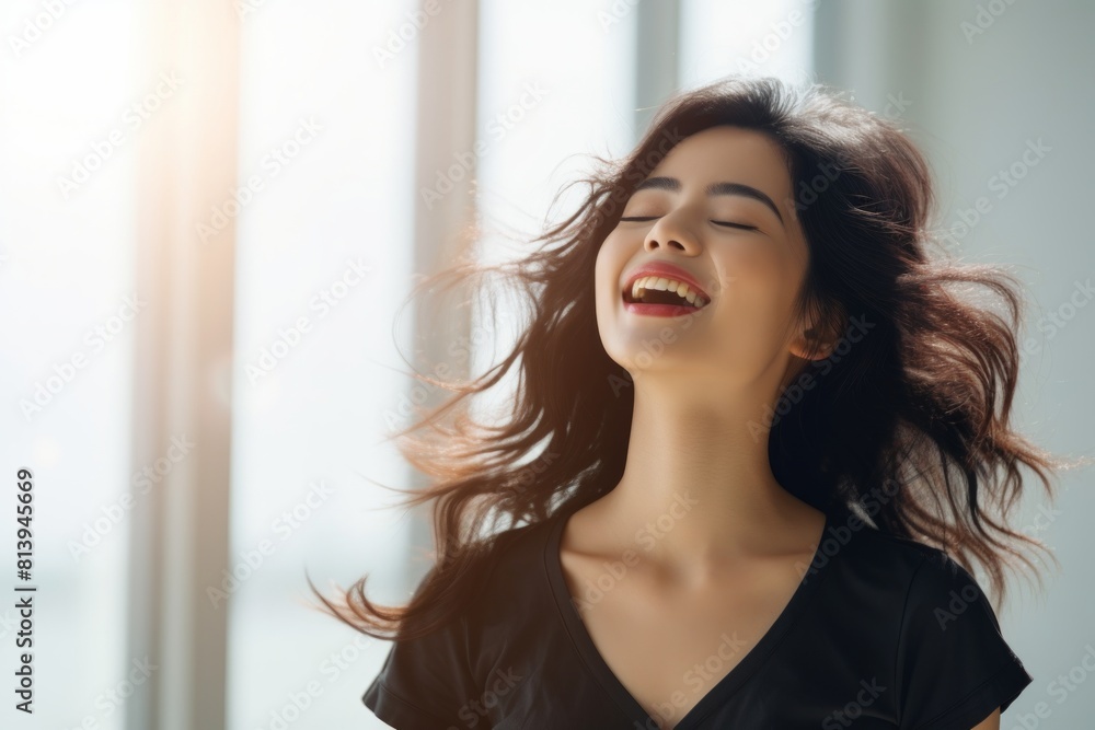 Portrait of a blissful asian woman in her 20s dancing and singing song in microphone while standing against modern minimalist interior Portrait of a blissful asian woman in her 20s dancing and singing song in microphone while standing against modern minimalist interior