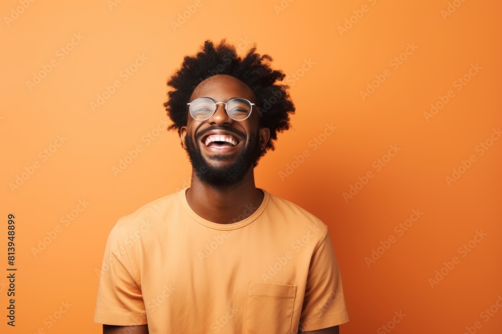 Portrait of a glad afro-american man in his 20s laughing in modern minimalist interior Portrait of a glad afro-american man in his 20s laughing in modern minimalist interior