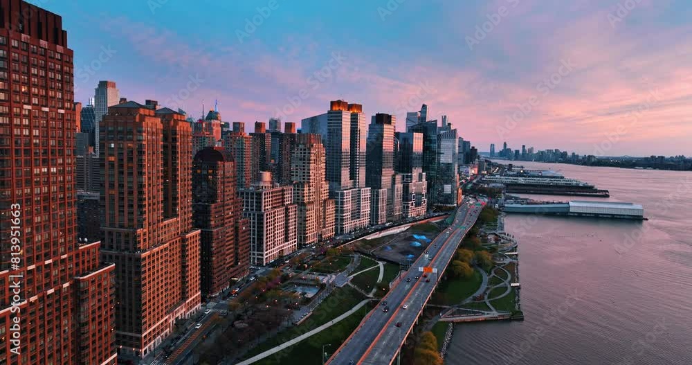 Flying along the beautiful buildings at the waterfront of the East River. New York architecture from top view at sunset. Flying along the beautiful buildings at the waterfront of the East River. New York architecture from top view at sunset.