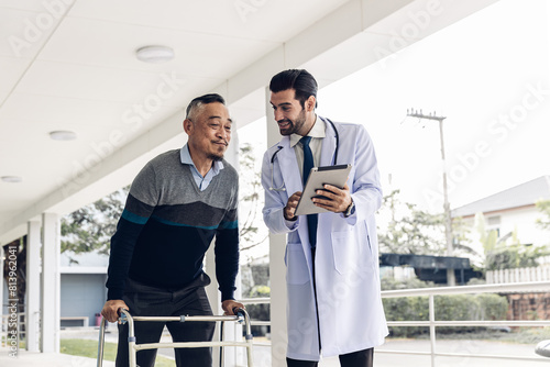 doctor or nurse helping Senior man to walk at nursing home with walker. Doctor or nurse helping old elderly man grandfather to walk using walker equipment