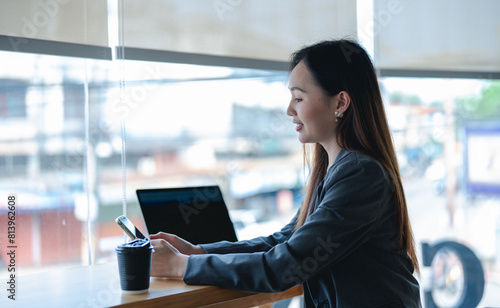 Asian young beautiful happy professional successful businesswoman designer sitting smiling at workstation desk using laptop notebook computer and smartphone working remotely online at home office Free Download Asian young beautiful happy professional successful businesswoman designer sitting smiling at workstation desk using laptop notebook computer and smartphone working remotely online at home office - GFXLoad
