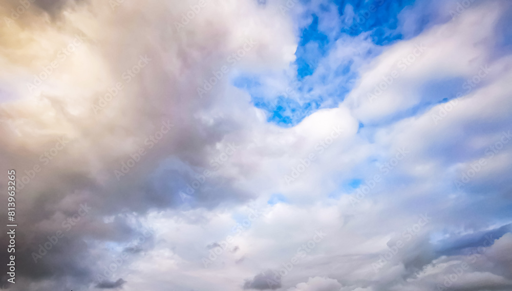 Ornamental clouds. Dramatic sky. Epic storm cloudscape. Soft sunlight. Panoramic image, texture, background.