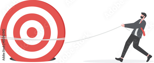 business goals. Businessman working hard to push target stuck in hole

