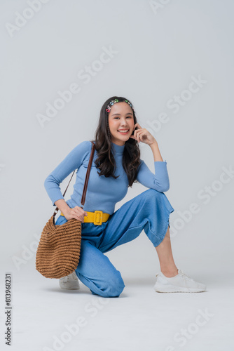 stylish asian woman fungy hipster blue cloth fashionista freshness dreass and makeup happiness confident playful asia woman charecter travel casual relax leisure lifestyle studio shot portriat smile photo