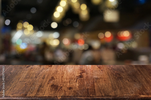 Empty dark wooden table in front of abstract blurred boken bankground of restaurant. Can used for display or montage your products. Mock up for space. © Nanthida