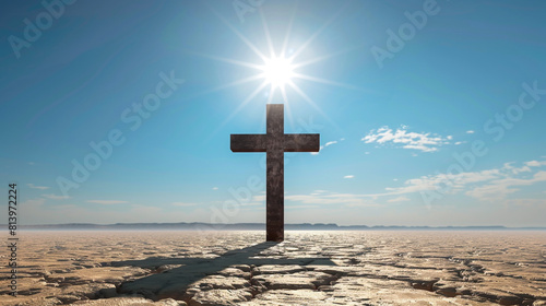 A Christian cross in the middle of a desert, with a clear blue sky and the sun blazing directly above, casting no shadow but illuminating the cross as a lone symbol of faith.