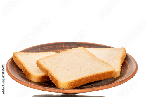 Three pieces of white toaster bread on a clay plate, macro, isolated on white background.