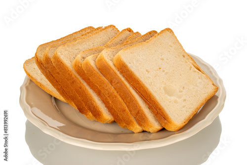 Several pieces of white toaster bread on a ceramic white plate, macro, isolated on a white background.