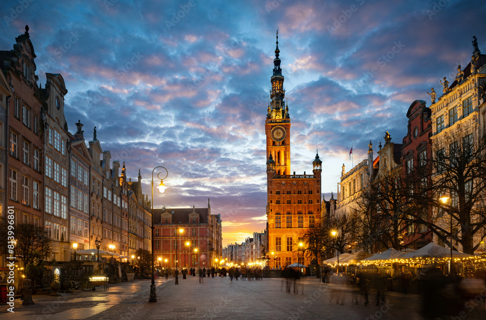 Fototapeta premium Street in an Old town and Town Hall in Gdansk, Poland. Panoramic evening view, long exposure, timelapse. Historical city of Gdansk (Danzig) , Poland, Europe.