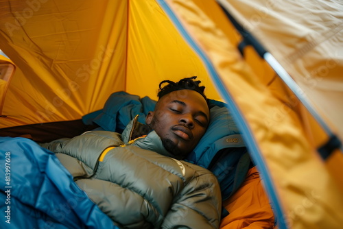 Closeup of a black man sleeping in a tent