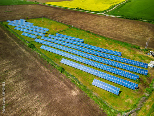 Solar panel produces green, environmentaly friendly energy from the setting sun. Aerial view from drone. Landscape picture of a solar plant that is located inside a valley
 photo