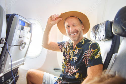 Εκτύπωση καμβά handsome adult male passenger having great time on flight.