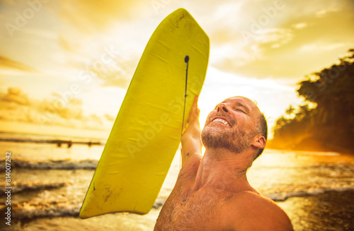 Photography Summer beach fun surfer man running with bodyboard on selfie style