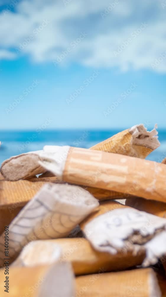 cigarettes butts piling up on beach in vertical format cigarettes butts piling up on beach in vertical format