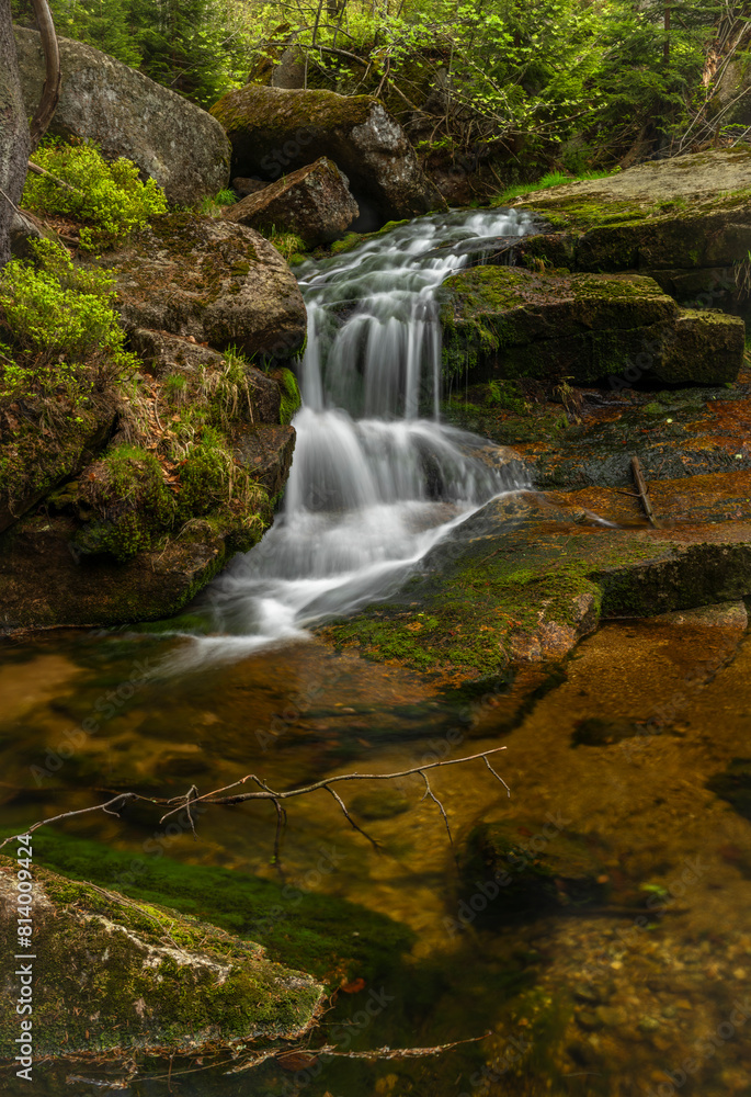 Fototapeta premium Jeleni waterfall in spring sunny cloudy day in Jizerske mountains