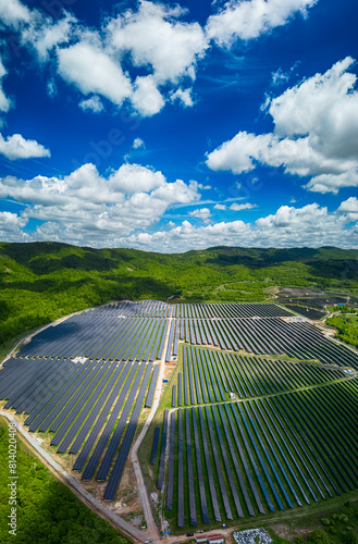 Solar panel produces green, environmentaly friendly energy from the setting sun. Aerial view from drone. Landscape picture of a solar plant that is located inside a valley
