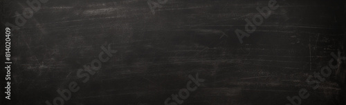 Textured blackboard surface with scratch marks  ideal for educational backgrounds  school-related designs. Realistic  black school board texture. Panoramic banner.