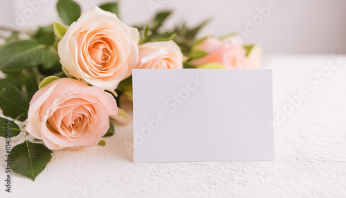 Mock-up of blank white paper card and bouquet of roses. Minimalist style. Floral composition.