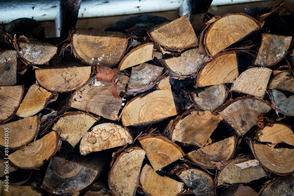 Pile of chopped firewood stored for winter heating Pile of chopped firewood stored for winter heating