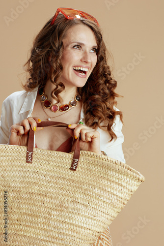 smiling female in blouse and shorts isolated on beige