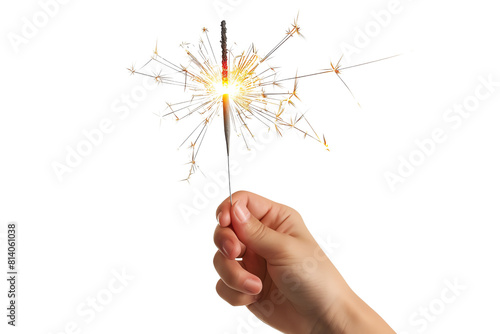 Hand holding a lit sparkler against a black background.