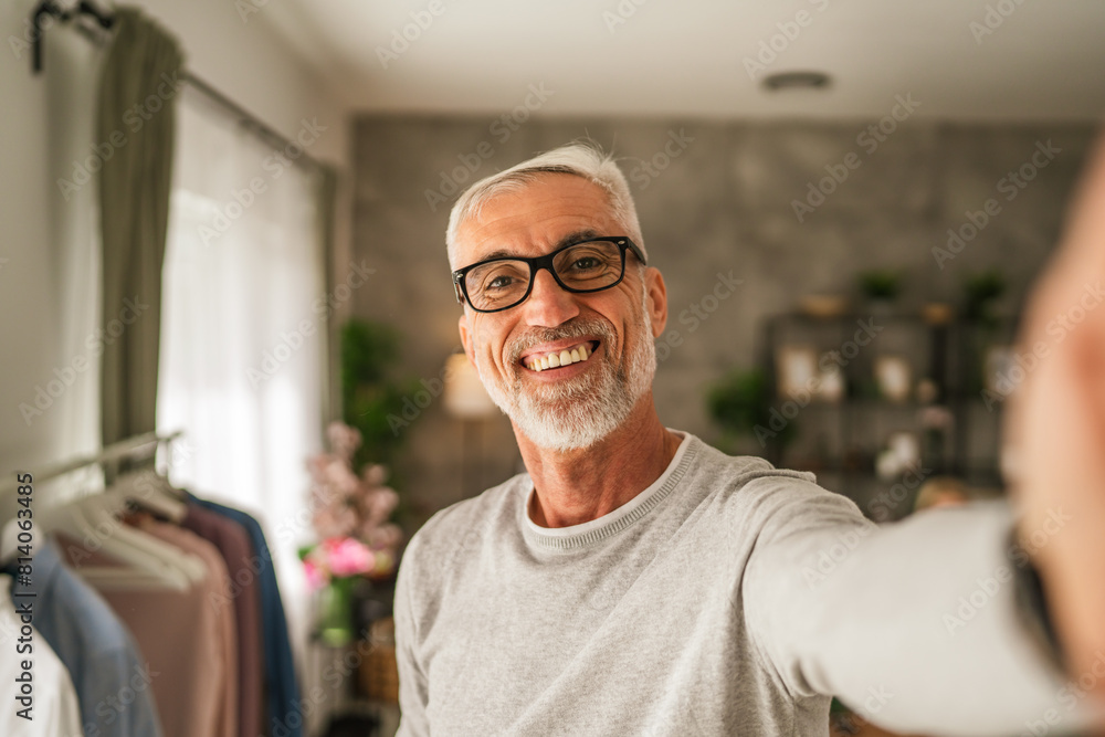 One mature man hold mobile phone and do self portrait of himself One mature man hold mobile phone and do self portrait of himself