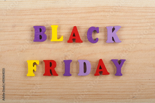 BLACK FRIDAY word on wooden background composed from colorful abc alphabet block wooden letters, copy space for ad text. Learning english concept. photo