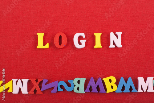 LOGIN word on red background composed from colorful abc alphabet block wooden letters, copy space for ad text. Learning english concept. photo