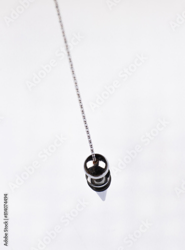 metal magic pendulum isolated on white background
