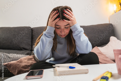 Young woman feeling stressed at home photo
