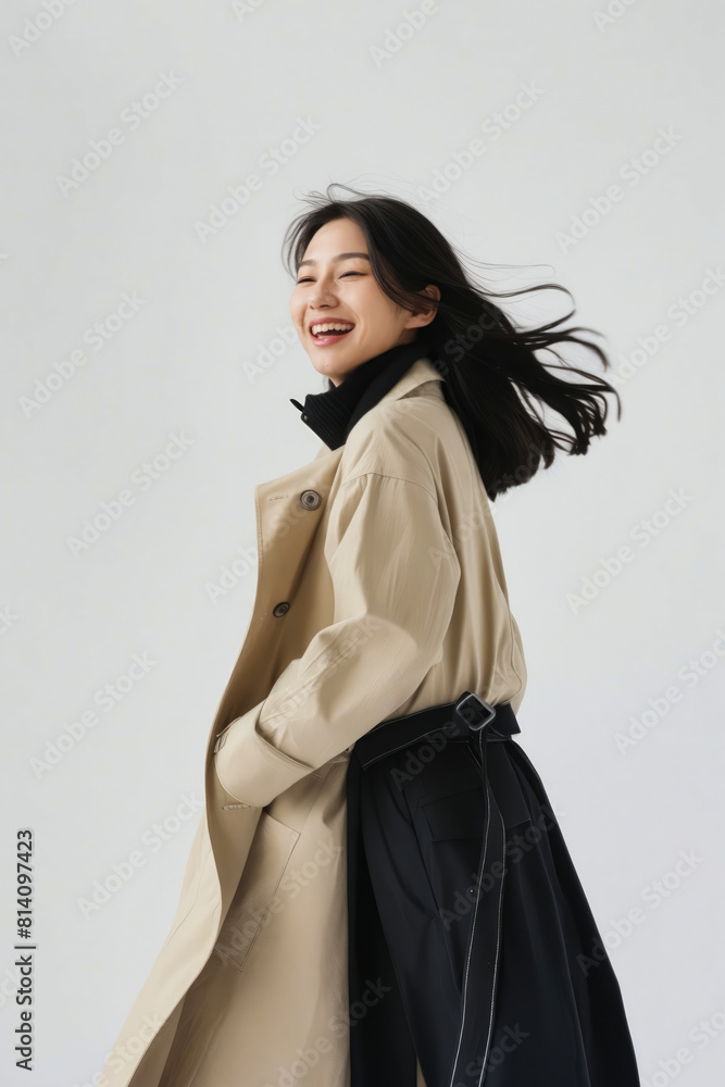A woman in a trench coat and black skirt. A woman in a trench coat and black skirt.