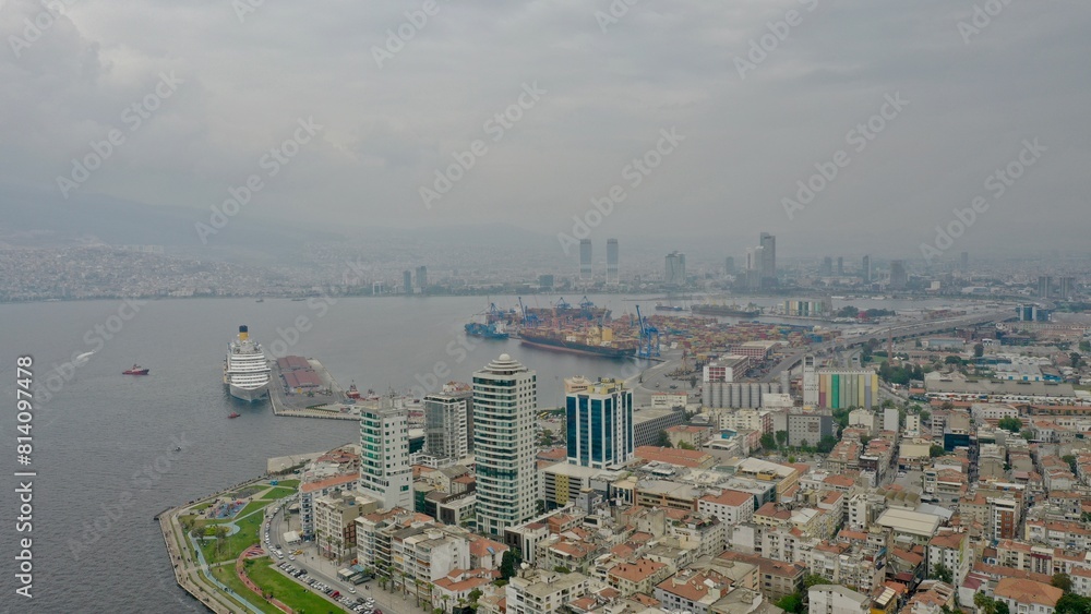 Obraz premium Cruise ship at sea docking at the port, on a cloudy day.