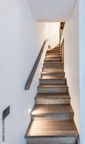 Modern Wooden Minimalism Style Stairs With Discrete Floor Night Lighting. New Wooden Staircase in Apartment House With Modern Interior Design