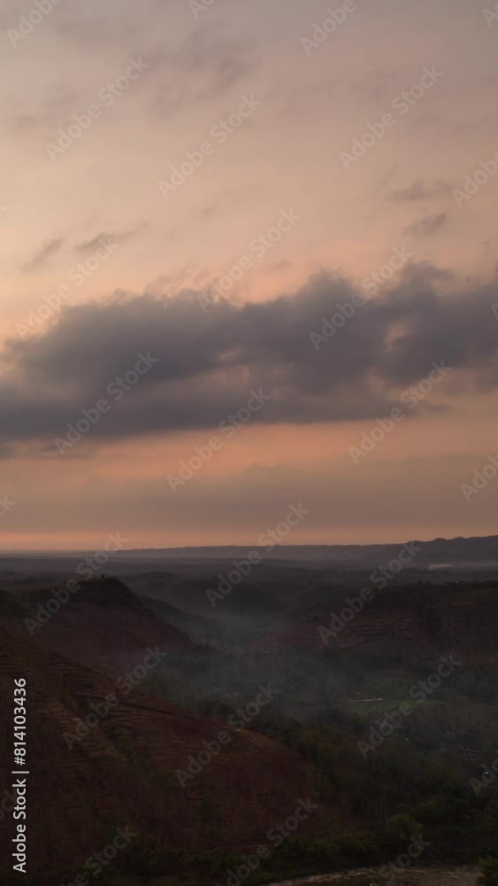 Vertical video - Cloudy sunrise timelapse over the hills Vertical video - Cloudy sunrise timelapse over the hills