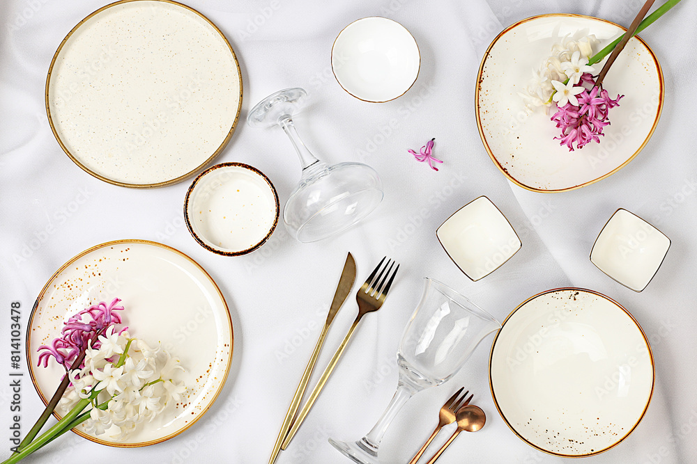 Elegant festive table setting, menu layout in a cafe or restaurant, cutlery with flowers on a plate on a marble background, festive composition with a bouquet of hyacinths, kitchen background. Elegant festive table setting, menu layout in a cafe or restaurant, cutlery with flowers on a plate on a marble background, festive composition with a bouquet of hyacinths, kitchen background.