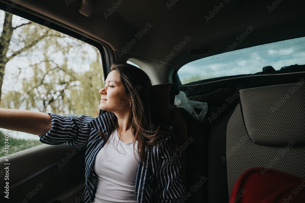 Content young woman with a serene expression resting her arm on car window, feeling the breeze on a tranquil journey. Content young woman with a serene expression resting her arm on car window, feeling the breeze on a tranquil journey.