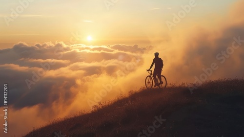Free man at the top of the mountain at the sunset on the bike