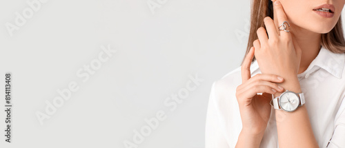 Woman with stylish wrist watch on white background photo