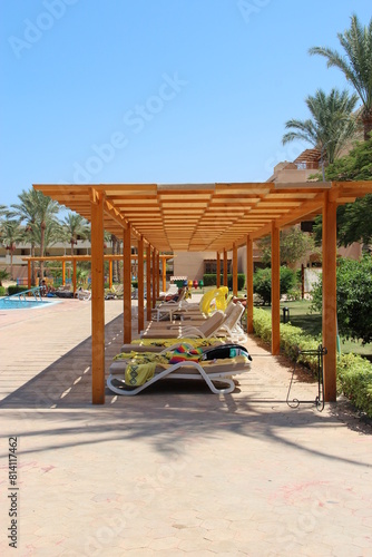 Wallpaper Mural Empty deck chairs with towels on tropical resort beach. Pair of chaise longues Torontodigital.ca