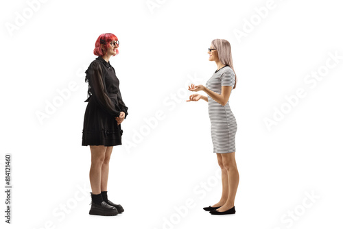 Full length profile shot of two young women discussing