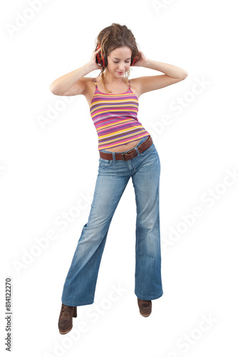 Joyful young woman who is listening to music through headphones, dancing, and singing while being isolated against a white background