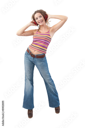 Joyful young woman who is listening to music through red headphones, dancing and looking at camera with her blue eyes while being isolated against a white background