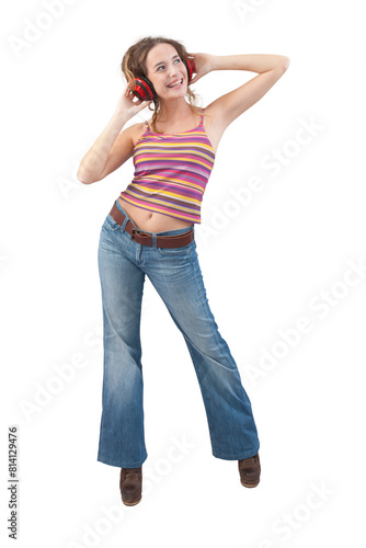 Joyful young woman who is listening to music through red headphones, dancing and looks to the side with her blue eyes while being isolated against a white background