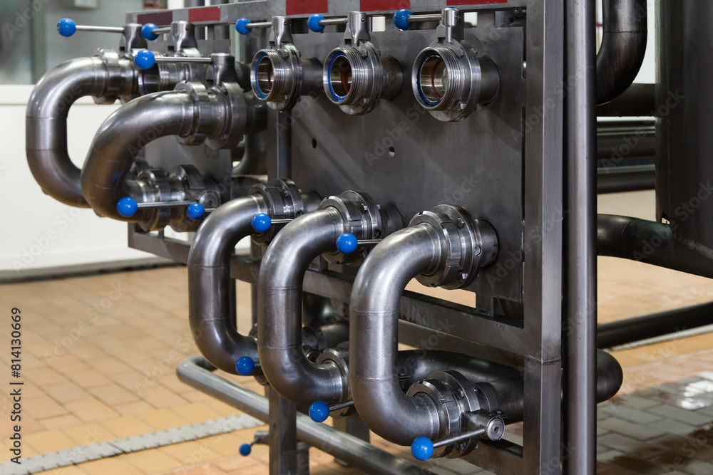 Industrial stainless steel pipework. Metal pipes, element of equipment design, of the milk production plant	