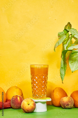 cup of orange and peaches juices with fresh fruits