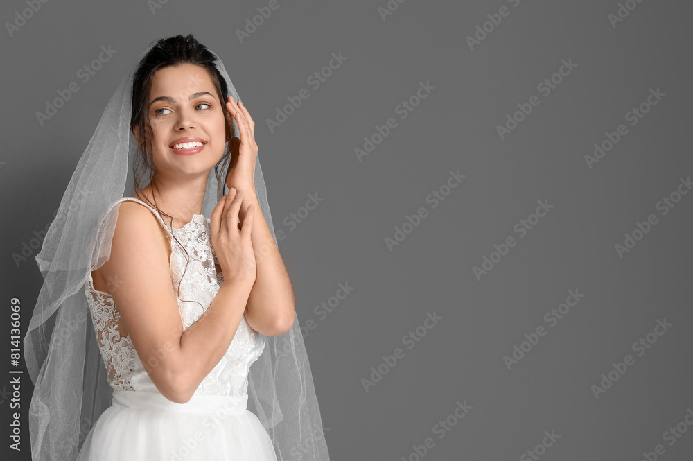 Young bride in wedding dress on dark background Young bride in wedding dress on dark background