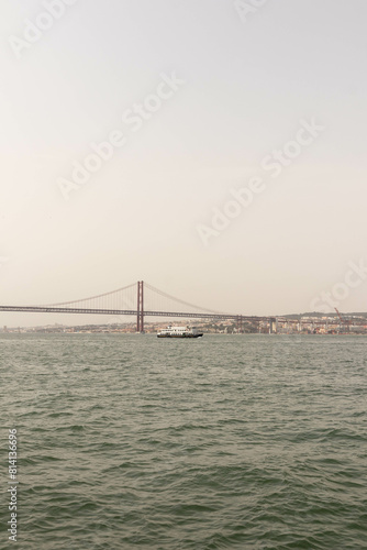 Fototapeta Naklejka Na Ścianę i Meble -  View of a Bridge in Lisbon Portugal Along the Water