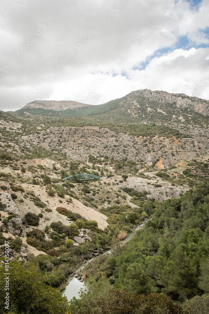 Fototapeta premium hiking trail caminito del rey, kings walkway, in Malaga Spain. narrow footpath leads through natural beauty mountain range cliff faces of gaitanes gorge. hisotric landmark popular tourist attraction